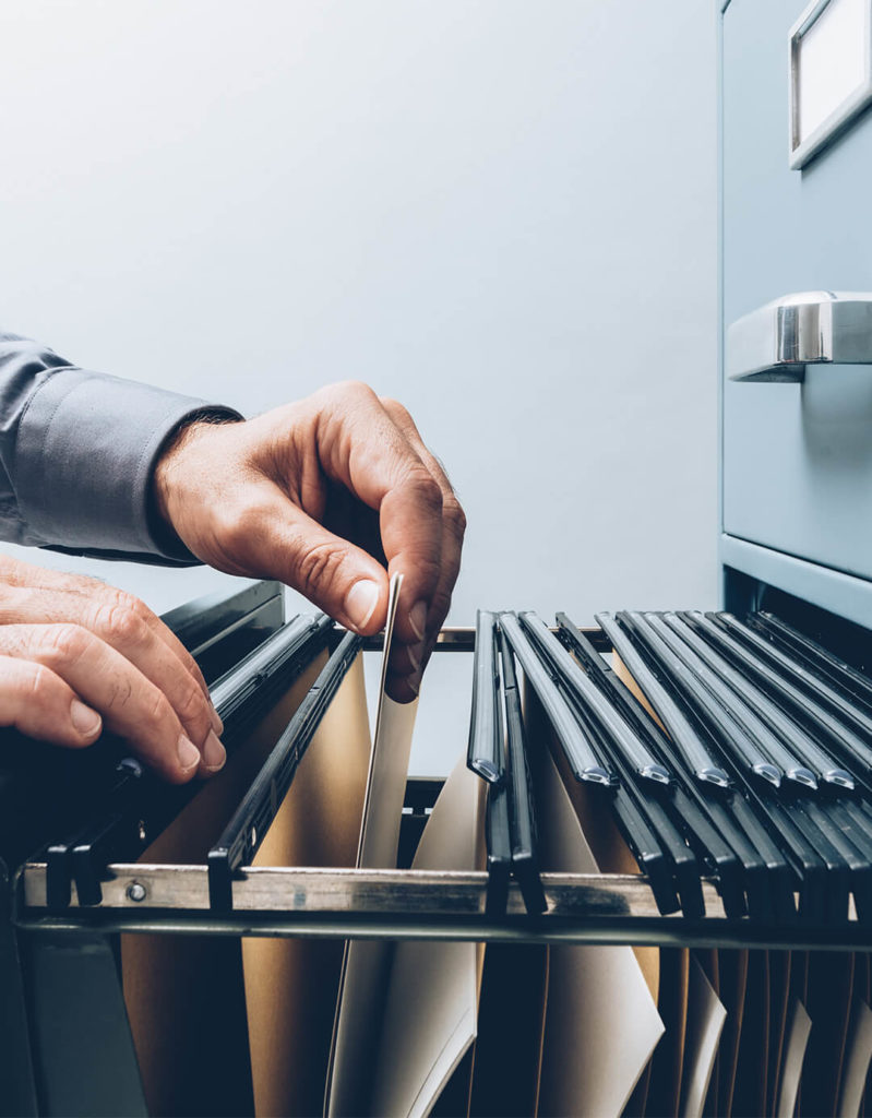 Person filing documents in a cabinet